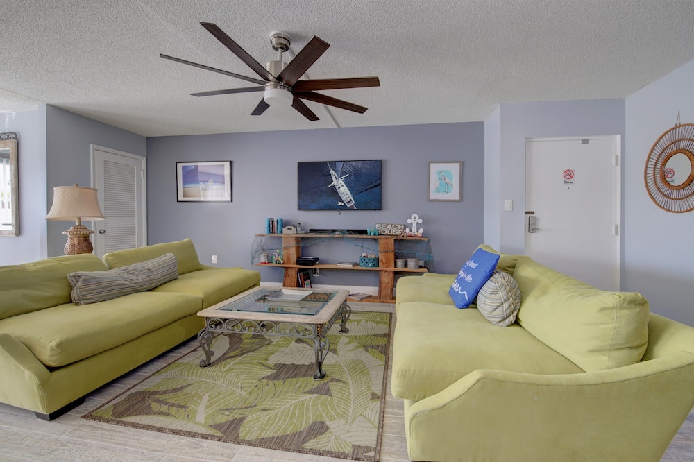 Guests are sure to enjoy a memorable vacation in this fully furnished, 2 bedroom/2 bath Condo. The main/master bedroom has a King-sized bed, while the remaining room is furnished with a Queen-sized bed, comfortable for sleeping 4 people. The newly decorated living room is furnished with two large couches, and a 65" TV w/ Sound Bar. The Dining area is coupled with the living room and is equipped with a large table for Six as well as a sitting counter and bar area. Situated 2 short blocks from the beach, guests can enjoy an afternoon of sunbathing, swimming, and sunsets or wind down right outside your door on the pool patio. <br><br>$$Save on Monthly Rates$$$<br> <br><br> Cozy Ground Floor Pool Access 2BR/2B