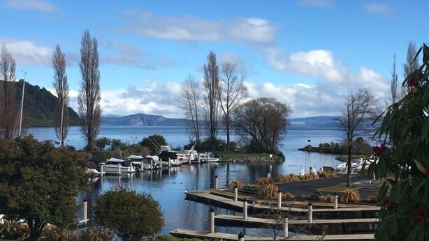 A marina with docked boats, surrounded by trees and a lake. - “CedarView at Kinloch” - a brilliant 3 bedroom holiday home with stunning views  (Kinloch)