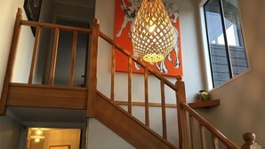 A wooden staircase with a hanging light fixture and a painting above. - “CedarView at Kinloch” - a brilliant 3 bedroom holiday home with stunning views  (Kinloch)