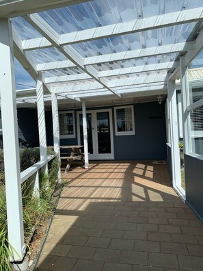 Under cover porch to front of house 