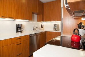 Enjoy cooking in this well-equipped kitchen with a stovetop, coffee maker, and dishwasher.