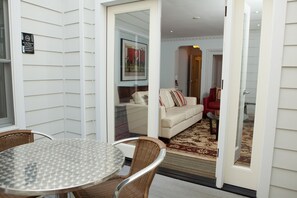 Relax in this inviting outdoor space with a round table and wicker chairs.