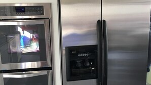 A stainless steel refrigerator with a water dispenser and a built-in oven. - The coast of Maine a spacious 10 bedroom home. Equipped with an in ground pool (Saco)