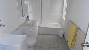 Combined shower/bathtub, hair dryer, soap, toilet paper - Dare Beach House Escape (Ocean Grove)