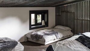 A small, cozy bedroom with a single bed, a window with a view, and a rustic ceiling. - WATERSHED Robertson - a chic shed conversion (Robertson)