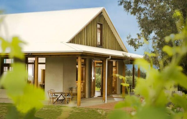 A two-story building with a gabled roof and wooden framing.