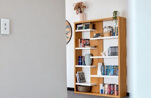 A bookshelf with various books and decorative items.