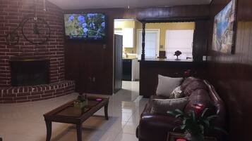 Una televisión, una chimenea, un reproductor de DVD, un futbolín