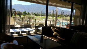 A room with a view of a pool and mountains. - Beautiful Desert Princess Resort Condo Awesome Views of Golf Course & Mountains  (Cathedral City)