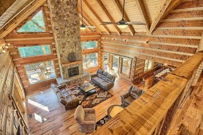 A spacious lodge with a high ceiling, stone fireplace, and large windows. - Wildcat Lodge - Luxury Accommodations (Rockbridge)