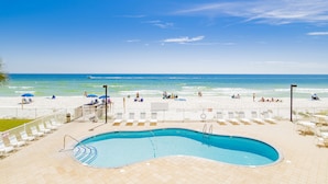 A pool area with a view of the beach and ocean. - Surfside Shores II 2204 Directly On The Gulf Of America (Gulf Shores)