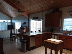 Enjoy cooking in this well-equipped kitchen with a large island and dining area.