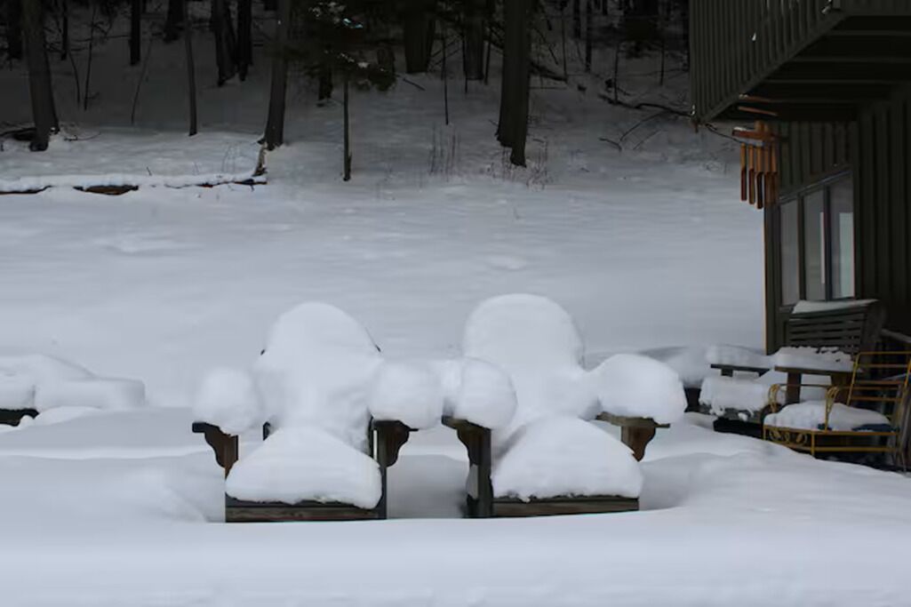 A snow-covered outdoor area with a building in the background.