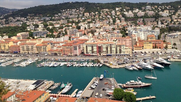 A marina with numerous boats docked, surrounded by densely packed buildings with varied architecture. - Apartment with a beautiful view in the Port ! (Nice)