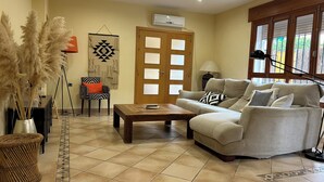 A living room with a sofa, coffee table, and decorative items.
