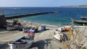 A coastal harbor with several boats docked along the shore.