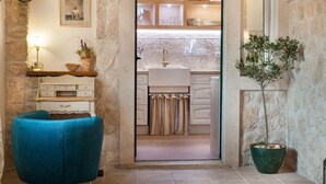 A cozy kitchen with a wooden countertop, a sink, and a potted plant. - Villa Oliva - exclusive gateway, luxurious serenity, stunning views, heated pool (Podgora)