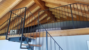 A wooden attic with a metal staircase and a loft-style bed. - LAKE ORTA - LAKE VIEW APARTMENT, PRIVATE BEACH AND BALCONIES (FIRST FLOOR) (Pettinasco)