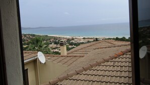 A view of a coastal town with terracotta rooftops and a satellite dish. - House / Villa - independent  with beautiful sight on the gulf (Costa Rei)