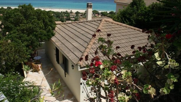 A house with a tiled roof, a chimney, and a view of the ocean. - House / Villa - independent  with beautiful sight on the gulf (Costa Rei)