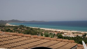 A coastal view with a beach, ocean, and distant mountains. - House / Villa - independent  with beautiful sight on the gulf (Costa Rei)