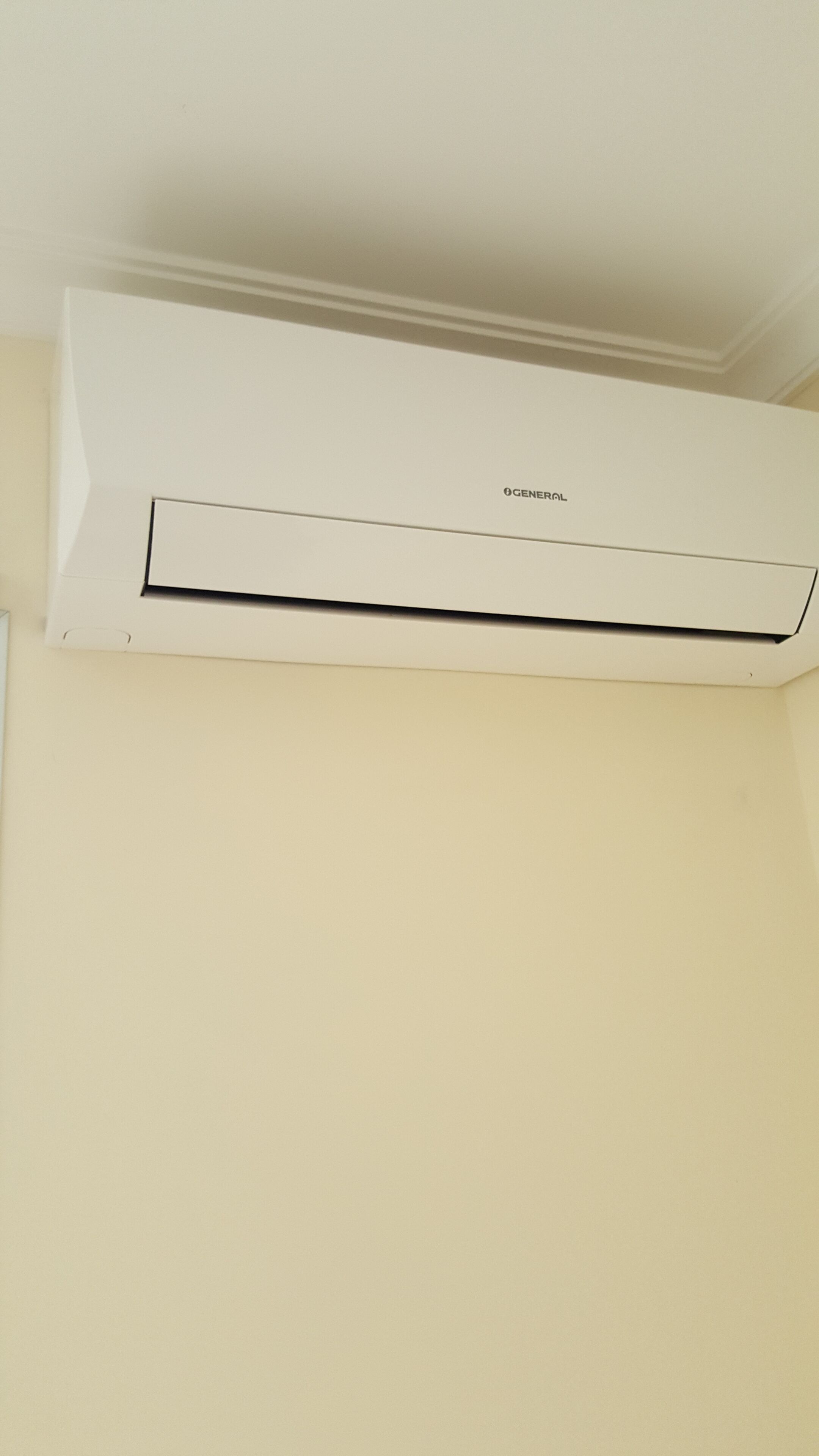 A white air conditioning unit mounted on a wall.
