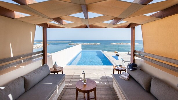 A sunlit outdoor seating area with a pool and ocean view. - CELESTINE, beach front villa with roof top pool and spectacular views. (Kolymvari)