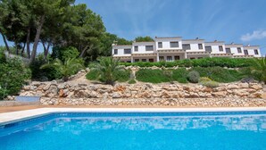 A two-story building with a pool in front.