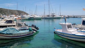 A marina with various boats docked, including a boat named "La Calera" and another named "Pascal K. Pedro".