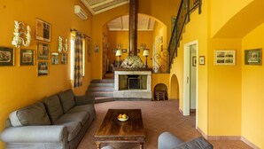 A spacious living room with a fireplace, a sofa, and a coffee table.