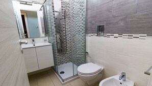 A modern bathroom with a glass shower enclosure, a toilet, and a sink. - B&B room with swimming pool (Gasponi)