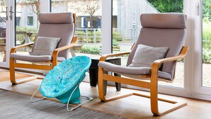 Two lounge chairs with cushions, a small table, and a blue chair with a colorful pattern. - Sleeps 8, 4 Bedrooms, Dogs Welcome, No Smoking, Wood burner, Wi-Fi*, Garden, Games Room (Cheltenham)