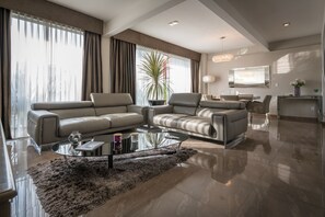 Relax in a stylish living room with a sleek sofa, flat-screen TV, and comfortable seating area.