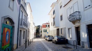 A narrow cobblestone street lined with white buildings, some with balconies and others with shutters. - House in the Historic Center of Cascais (Cascais)