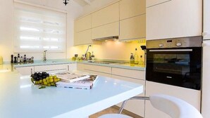 A modern kitchen with a light blue countertop, a built-in oven, and white cabinetry. - Villa With Private Heated Pool(optional extra) And Sea Views (Kalkan)
