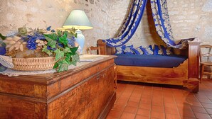 A rustic bedroom with a wooden bed, a nightstand, and a lamp.
