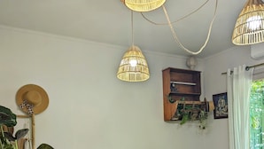 A bedroom with a bed, bedside tables, a hanging lamp, and a window with curtains. - Pinarello: CHARMING HOUSE 400m FROM THE BEACH, SWIMMING POOL AND SPA (Zonza)