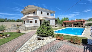 A two-story house with a swimming pool, stone pathway, and a small garden area. - Acharavi Beach Villa - Luxury Seaside Villa Rental in Acharavi, Island of Corfu. (Acharavi)