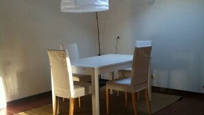 A dining area with a white table and chairs, a hanging light fixture, and a skylight. - 5 MINUTES FROM THE S. LUCIA TRAIN STATION (Venezia)