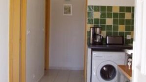 A compact kitchen with a washing machine, a microwave, and a toaster on the counter. - Apartment/ flat - Pieve (Piève)