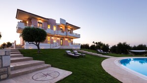A modern two-story house with a swimming pool, a well-maintained lawn, and outdoor seating. - Aelia Residence, Wellness & Leisure with 100m² Heated Pool, Whirlpool, Sauna&Gym (Rethymnon)