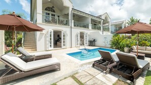 A two-story house with a swimming pool, outdoor seating, and a balcony. - Sugar Cane Ridge 23 (St James)