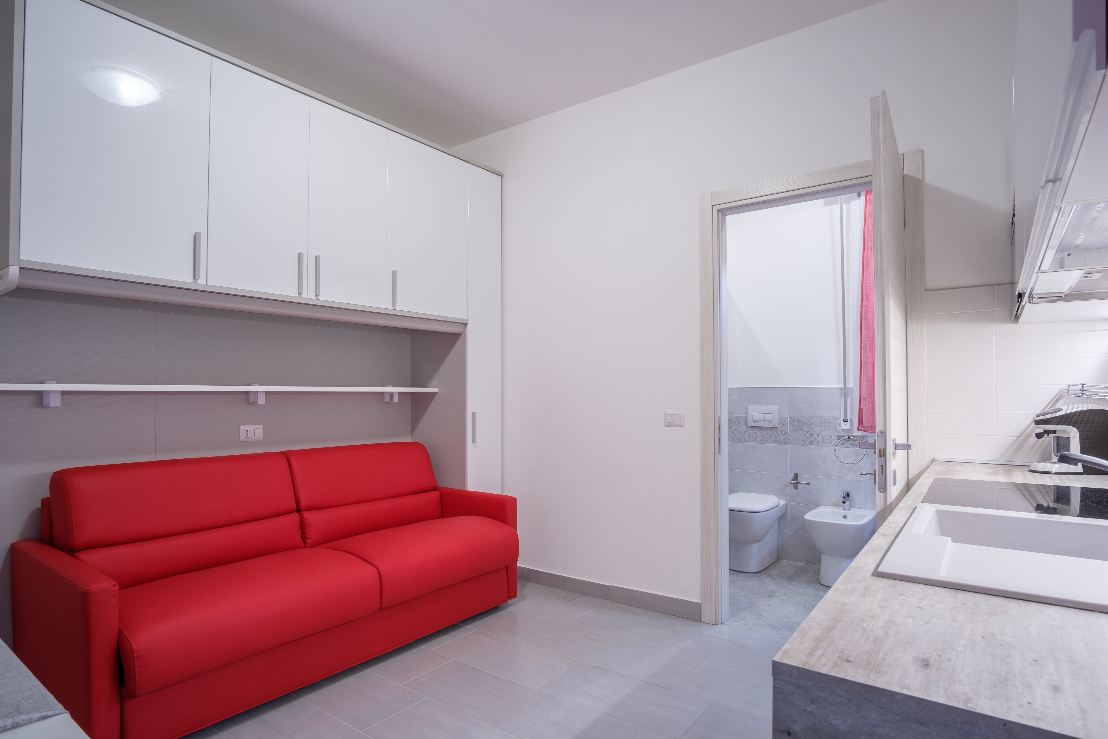 A modern bathroom with a toilet, bidet, and sink.