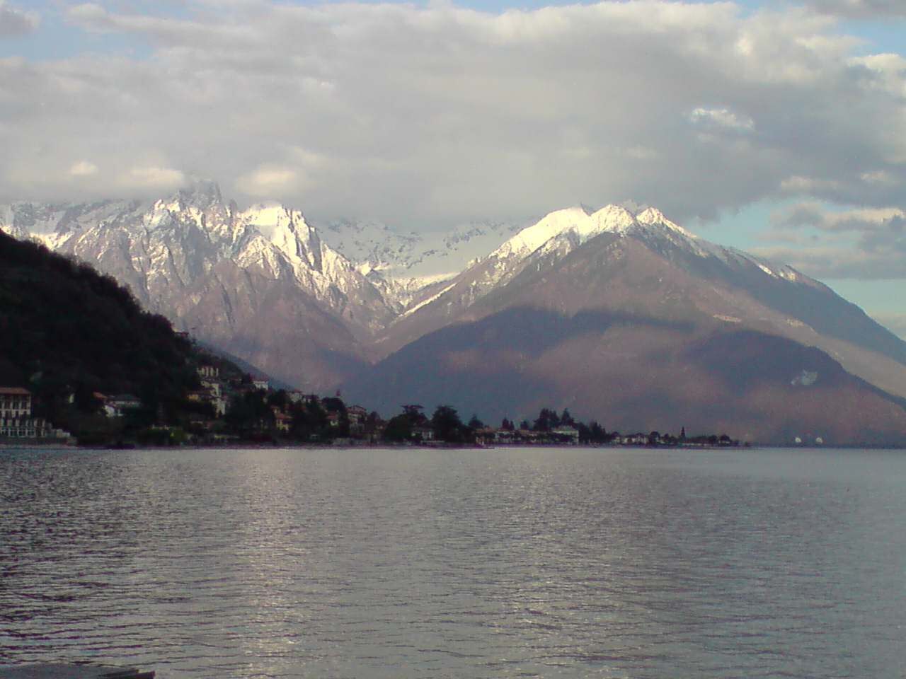 A lake with a mountain range in the background.