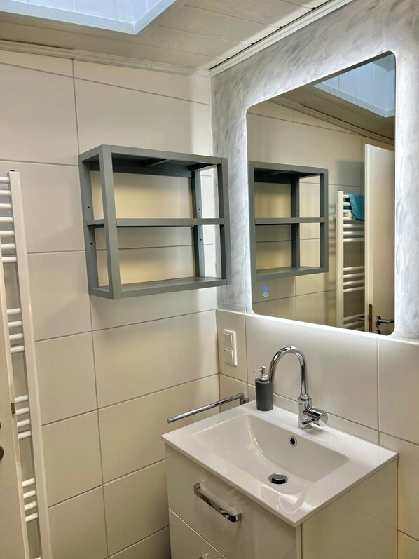 Shower, hair dryer, towels, toilet paper