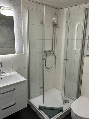 Shower, hair dryer, towels, toilet paper