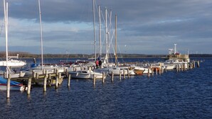 Ein Yachthafen mit verschiedenen Booten, die an Holzstegen festgemacht sind.