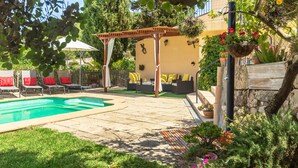A pool area with lounge chairs, a pergola, and a covered seating area. - Finca Son Rebassa (Sant Joan)