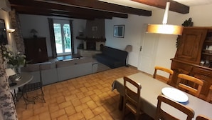 A cozy kitchen with a dining area, wooden cabinets, and a fireplace. - Villa sleeps 8, 2 shower rooms, summer kitchen, heated pool, shaded parking. (Mornas)