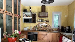 A compact kitchen with wooden cabinets, a microwave, a stove, and a coffee maker. - The house of Elorac St Remy de Provence with private pool (Saint-Rémy-de-Provence)
